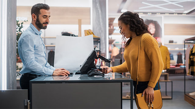 Woman using payment card in retail outlet